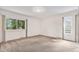 Spacious carpeted bedroom featuring natural light from the large windows at 2743 S Reading Ct, Denver, CO 80231
