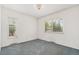 Bright bedroom with natural light from two windows and a decorative chandelier at 2743 S Reading Ct, Denver, CO 80231