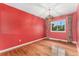 Dining room with hardwood floors, chandelier, and large window at 2743 S Reading Ct, Denver, CO 80231