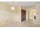 Bright dining area featuring tile flooring, a modern light fixture, and neutral walls at 2743 S Reading Ct, Denver, CO 80231