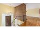 Inviting foyer with hardwood floors, brick wall, and elegant chandelier at 2743 S Reading Ct, Denver, CO 80231