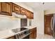 Updated kitchen with stainless steel appliances, wood cabinetry, and an abundance of counter space at 2743 S Reading Ct, Denver, CO 80231