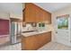 View of kitchen featuring stainless refrigerator, and plenty of counter space at 2743 S Reading Ct, Denver, CO 80231