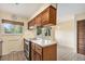 Kitchen featuring a center island with cooktop, warm toned wood cabinets, and eat in area at 2743 S Reading Ct, Denver, CO 80231