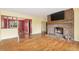 Open living room with a brick fireplace, hardwood floors, and a bright atmosphere at 2743 S Reading Ct, Denver, CO 80231