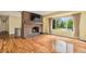 Cozy living room featuring a fireplace, hardwood floors and large window at 2743 S Reading Ct, Denver, CO 80231