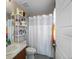 Well-organized bathroom with a large vanity, toilet, and shower with white shower curtain at 41 Jordan Ln, Erie, CO 80516