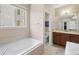 Bright bathroom featuring double sinks, tile flooring, and a soaking tub at 41 Jordan Ln, Erie, CO 80516