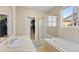 Bathroom featuring a glass enclosed shower, soaking tub and a large walk-in closet at 41 Jordan Ln, Erie, CO 80516