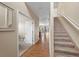 Inviting foyer with hardwood floors, staircase, and view of open-concept kitchen at 41 Jordan Ln, Erie, CO 80516