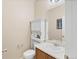 A well-lit half bathroom with a white vanity and a framed mirror at 41 Jordan Ln, Erie, CO 80516
