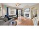 Bright and airy living room features a fireplace, hardwood floors, and plenty of seating at 41 Jordan Ln, Erie, CO 80516