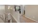 View of the loft area from the stairway with a ceiling fan and lots of light at 41 Jordan Ln, Erie, CO 80516