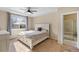 Comfortable main bedroom features a tray ceiling, ceiling fan and an ensuite bathroom at 41 Jordan Ln, Erie, CO 80516