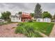 Exterior of home with a spacious backyard, including a lawn, shed, and mature trees at 744 Memphis St, Aurora, CO 80011