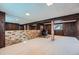 Finished basement with mirrored wall, brick accents, and a fireplace, creating a versatile living space at 744 Memphis St, Aurora, CO 80011