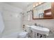 Bright bathroom with tiled walls, classic fixtures, vanity with a sink, and a shower-tub combination at 744 Memphis St, Aurora, CO 80011