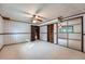 Cozy bedroom with wallpaper, ceiling fan, sliding door closet, and an adjoining room at 744 Memphis St, Aurora, CO 80011