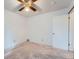 This is a bedroom with neutral carpet, a ceiling fan, and a white door, ready for your personal touches at 744 Memphis St, Aurora, CO 80011