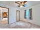 This is a bedroom with neutral carpet, a ceiling fan, a window, and a closet, perfect for relaxation at 744 Memphis St, Aurora, CO 80011