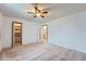 Spacious bedroom with neutral carpet, ceiling fan, closet, and white walls ready for personalization at 744 Memphis St, Aurora, CO 80011