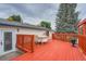 Outdoor deck features bright red planks and a dining set, great for entertaining at 744 Memphis St, Aurora, CO 80011