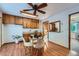 Cozy dining area featuring light wood floors, table with modern chairs and custom-built wood cabinets above the counter at 744 Memphis St, Aurora, CO 80011