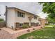 Side view of a charming house with manicured landscaping and a walkway at 744 Memphis St, Aurora, CO 80011
