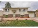 Charming home with a well-maintained lawn, brick accents, and inviting curb appeal at 744 Memphis St, Aurora, CO 80011