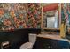 Stylish powder room with floral wallpaper, a granite countertop, and a framed mirror at 1531 S Owens St # 23, Denver, CO 80232