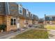 A well-maintained brick townhome with a tidy front lawn, sidewalk, and an inviting entrance at 1531 S Owens St # 23, Denver, CO 80232