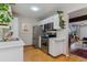 Compact kitchen featuring white cabinets, stainless steel appliances, and hardwood floors at 1531 S Owens St # 23, Denver, CO 80232