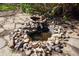 Backyard water feature with mature landscaping and rock details at 10200 Julian St, Westminster, CO 80031