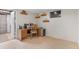 Finished basement office space with built in shelving, carpet floors, desk, and natural light from the window at 10200 Julian St, Westminster, CO 80031