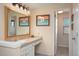 Bathroom features a large mirror, vanity, and tiled floors at 10200 Julian St, Westminster, CO 80031