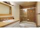 Bathroom with bath tub, shower, tiled sink and gold-framed mirror at 10200 Julian St, Westminster, CO 80031