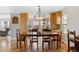 Inviting dining room with wood floors, large windows, and stylish lighting fixture at 10200 Julian St, Westminster, CO 80031