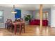 Spacious dining area with wood floors, a large table with seating, and a stylish light fixture at 10200 Julian St, Westminster, CO 80031