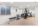 Bright and spacious home gym complete with large mirror, weight bench, and a variety of free weights at 10200 Julian St, Westminster, CO 80031