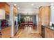 Stylish kitchen with wood cabinets, granite countertops, stainless steel appliances, and an open layout to the dining area at 10200 Julian St, Westminster, CO 80031