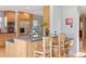 Kitchen island with breakfast bar featuring granite countertops and wood cabinetry at 10200 Julian St, Westminster, CO 80031