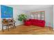 Features a bright living area with wooden floors, a red couch, and a window with wooden shutters at 10200 Julian St, Westminster, CO 80031