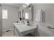 Modern bathroom with a white vanity, large mirror, and a clean aesthetic at 290 Glencoe St, Denver, CO 80220