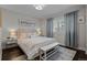 Bright bedroom with a light wood bed frame, soft color palette, and dark hardwood floors at 290 Glencoe St, Denver, CO 80220