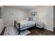 Cozy bedroom with a comfortable bed and dark wood floors at 290 Glencoe St, Denver, CO 80220