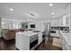 Open concept kitchen with a large island, stainless steel appliances, and a living area view at 290 Glencoe St, Denver, CO 80220