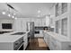 Modern kitchen with white cabinets, stainless steel appliances, and an island at 290 Glencoe St, Denver, CO 80220