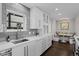 Bright kitchen with white cabinets, gray tile backsplash, and a breakfast nook at 290 Glencoe St, Denver, CO 80220