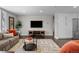 Living room featuring a sectional sofa, flat-screen TV, and stylish rug at 290 Glencoe St, Denver, CO 80220