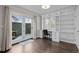 Home office with built-in shelving, desk, and French doors leading to a patio at 290 Glencoe St, Denver, CO 80220